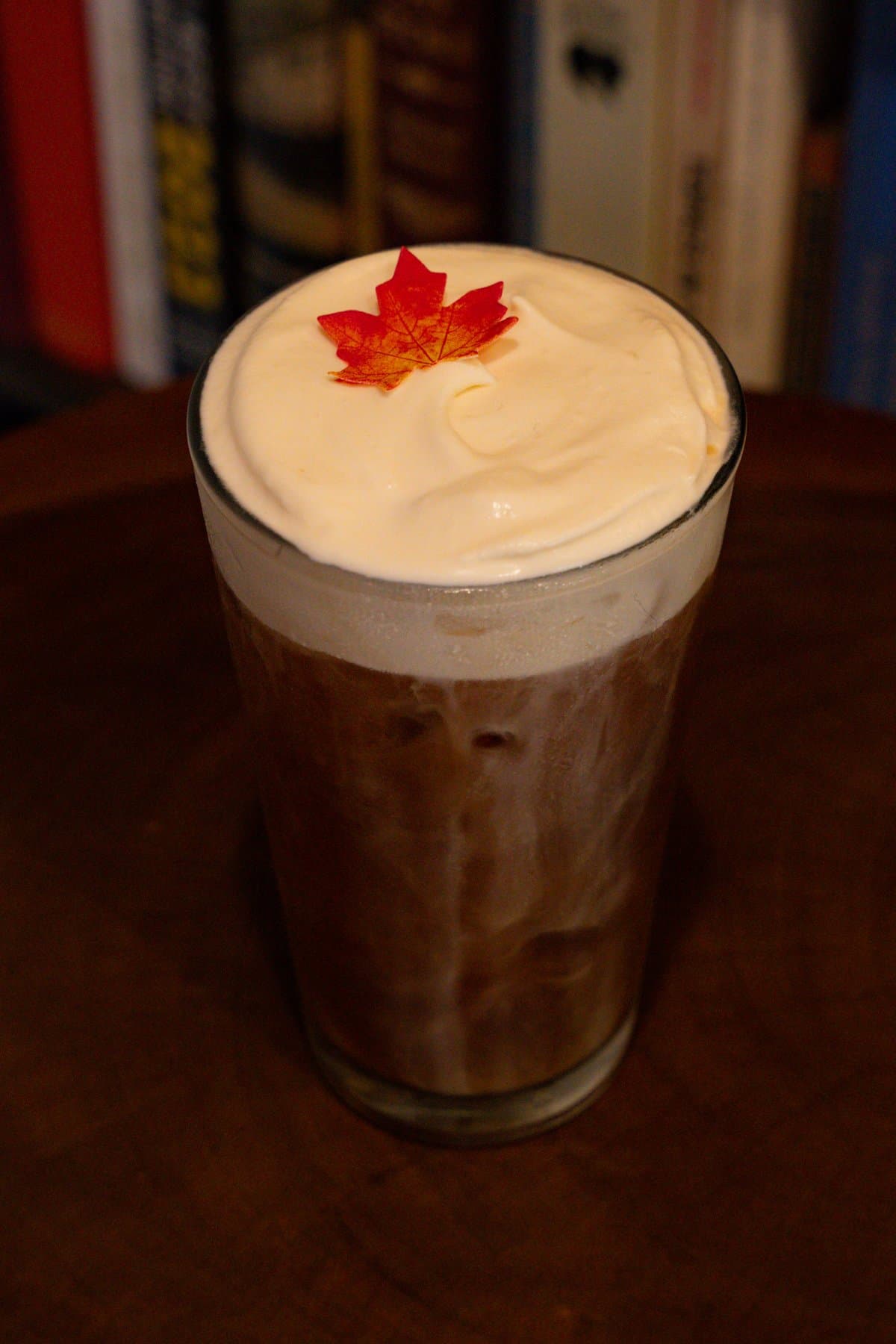 Brown Butter Maple Cold Brew topped with cold foam and a red maple leaf