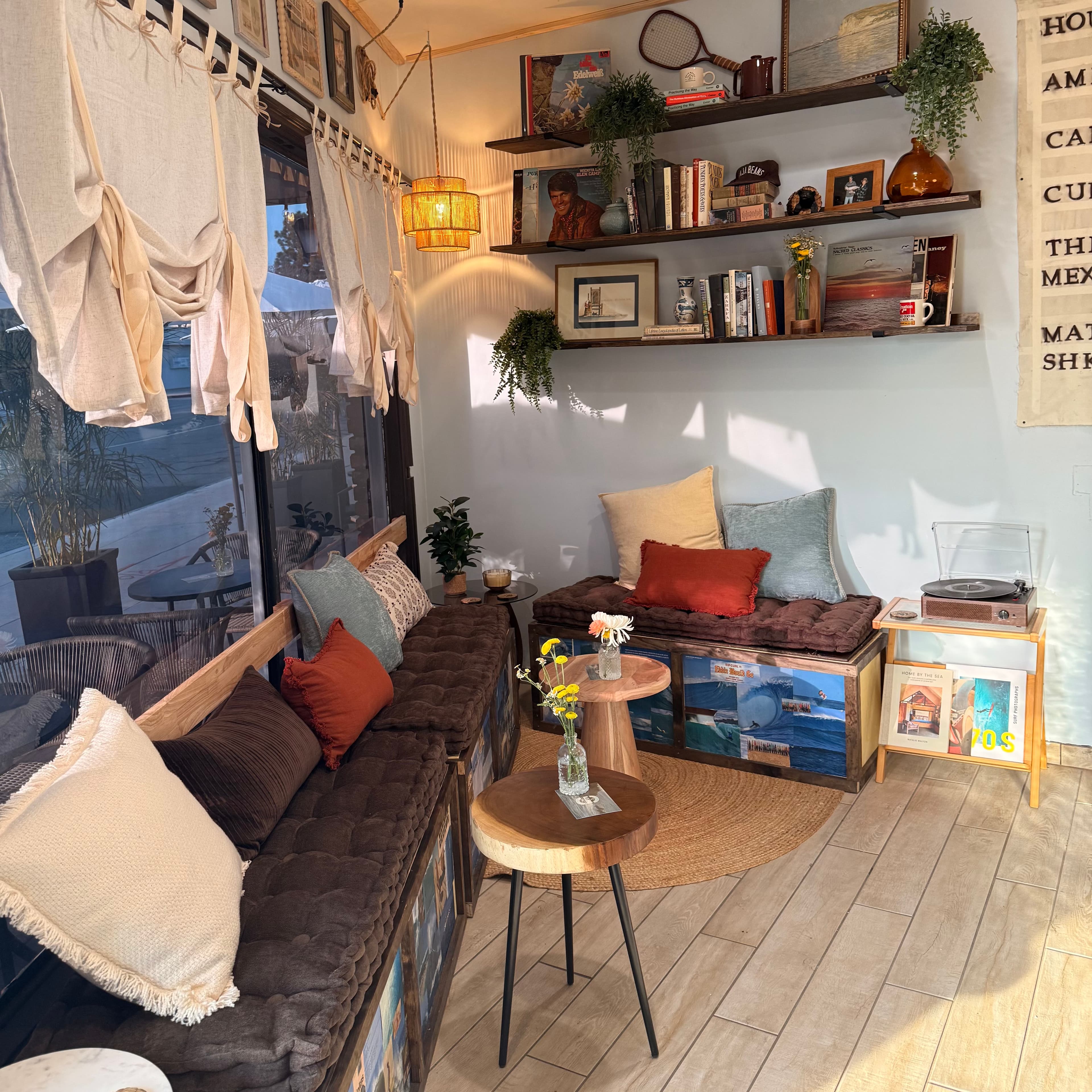 The lounge corner at Baja Beans — couches, shelves, record player